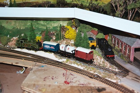 No.30 'Eldarion' waits to leave the Buckland freight siding with a Shire Freight train bound for Hobbiton. To the right is an unidentified Hymek, and No.34 'Pumpkin' sits outside the shed.