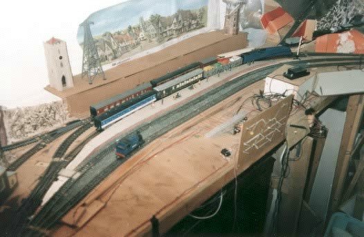 View of Hobbiton showing 'Nellie' (light-engine), No.15 'Elrond' (Mallard) hauling the motor-rail and a Shire passenger hauled by No.17 'Serrelind'.