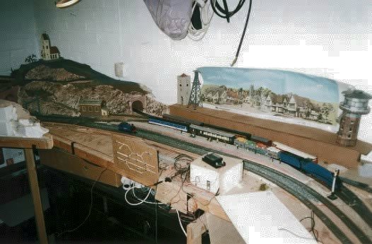 View of Hobbiton showing 'Nellie' (light-engine), No.15 'Elrond' (Mallard) hauling the motor-rail and a Shire passenger hauled by No.17 'Serrelind'.