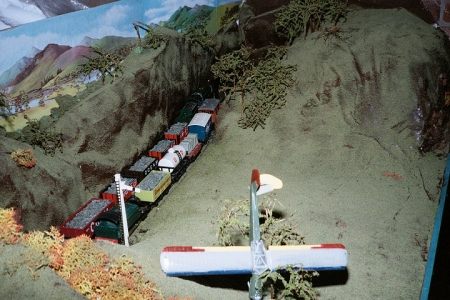 No.5 'Gandalf', hauling a coal train, passes No.13 'Ranger' waiting at the signal with a mixed freight.